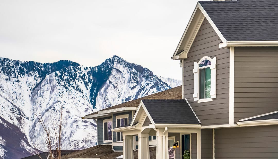 Exterior of a home with snow covered mountains in the background